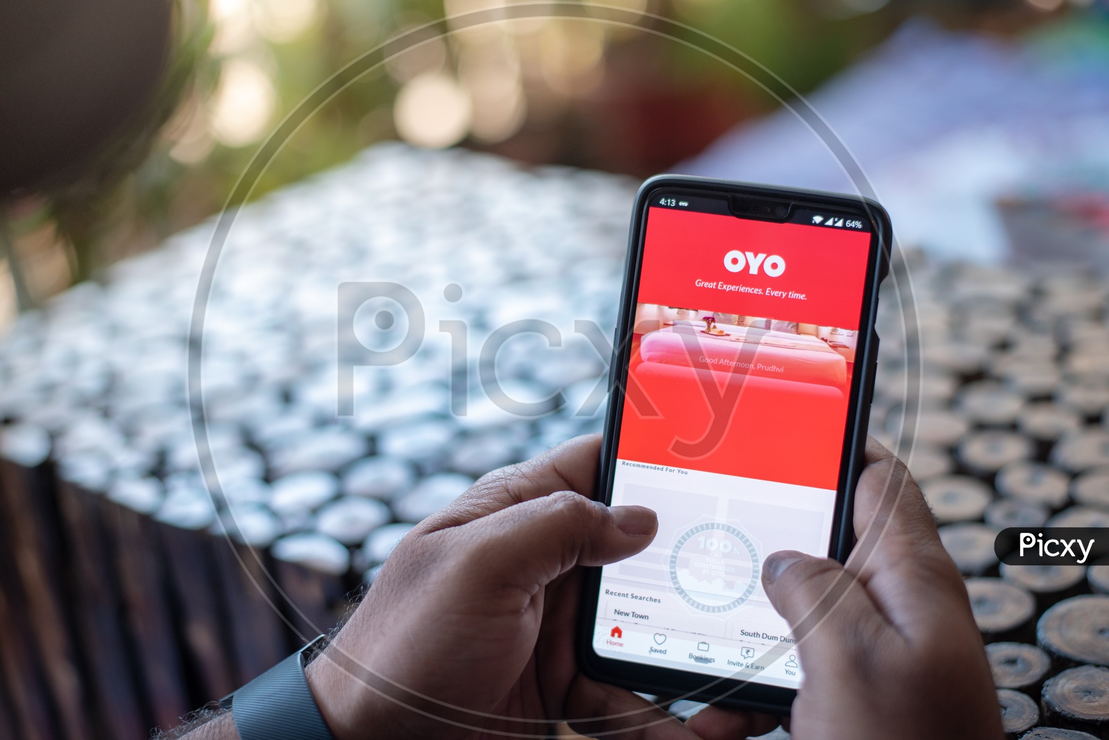Indian Man Using OYO App for Hotels Booking in Smart Phone