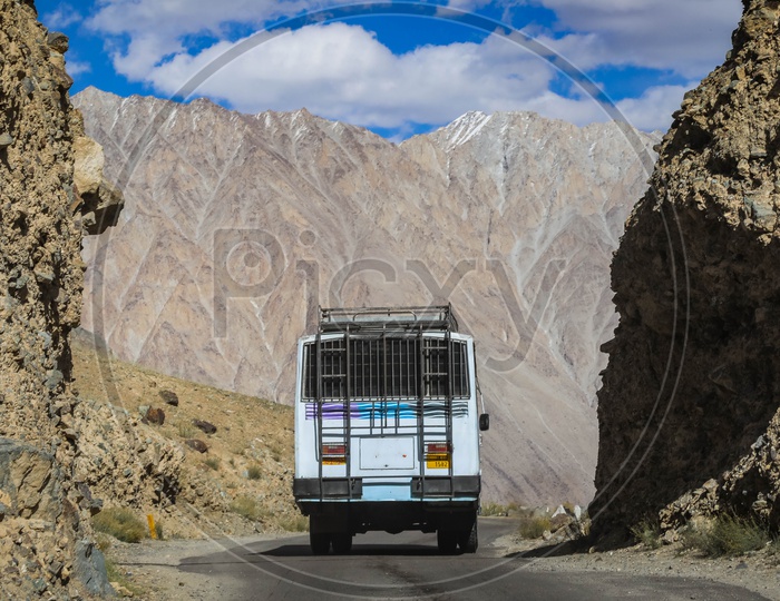 Moving bus on the roadway through the mountains