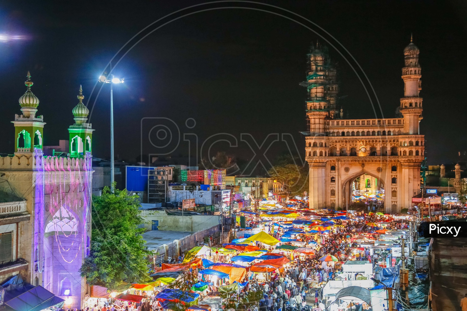 View of Charminar during the night alongside the crowd in street market