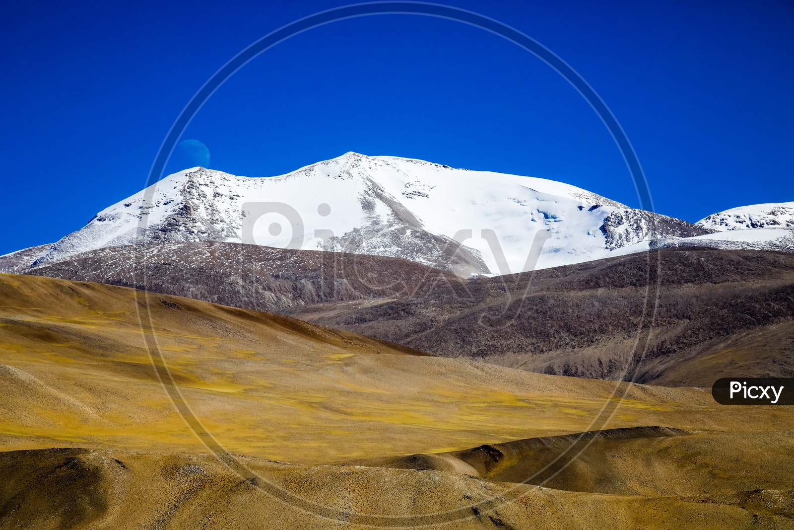Landscape of the snow covered mountains with blue sky