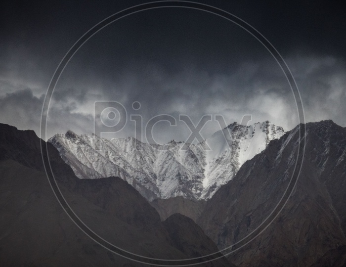 Dark clouds covered snowy Himalayan ranges