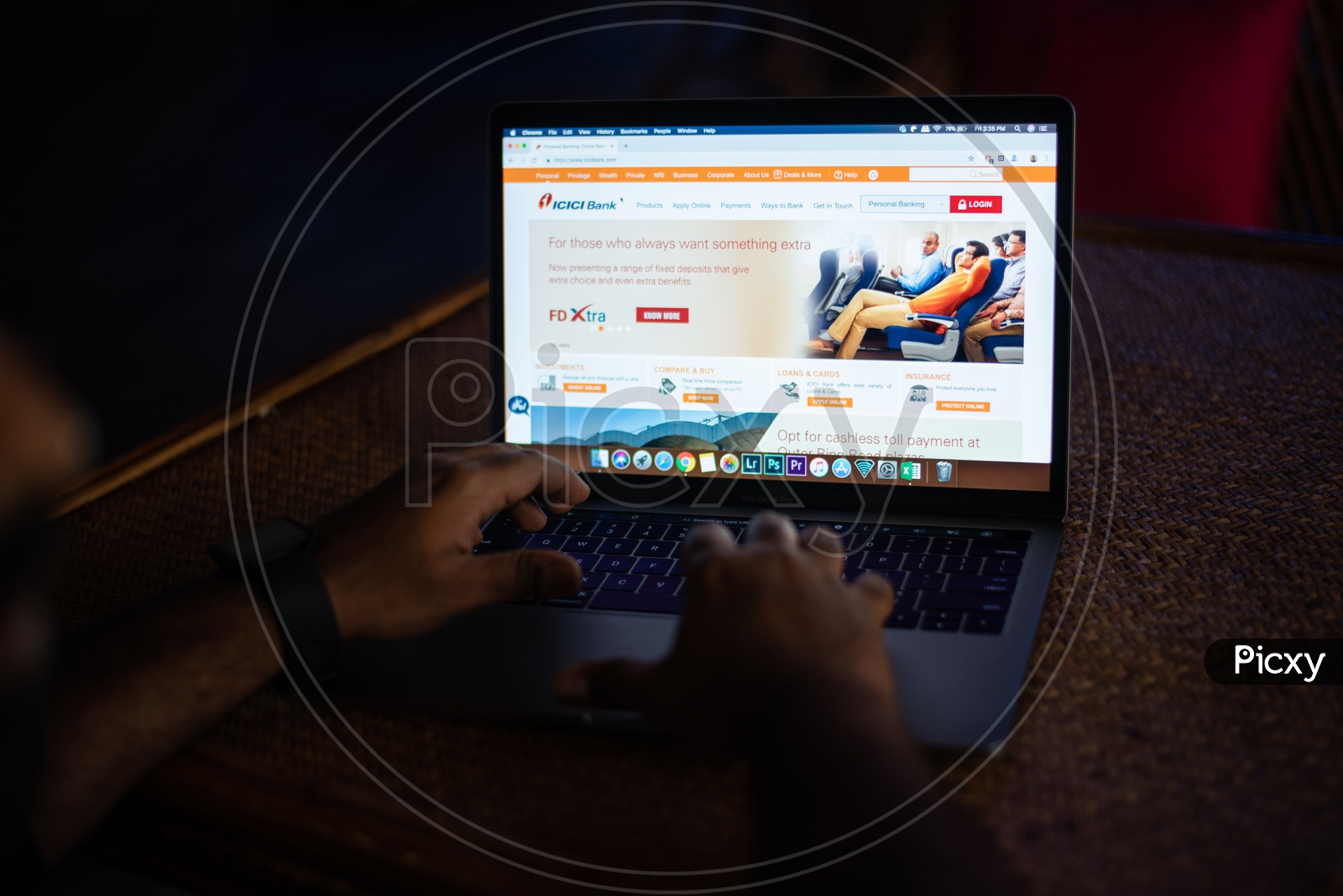 Indian Youth Accessing Online Banking Of ICICI  BANK  in Laptop