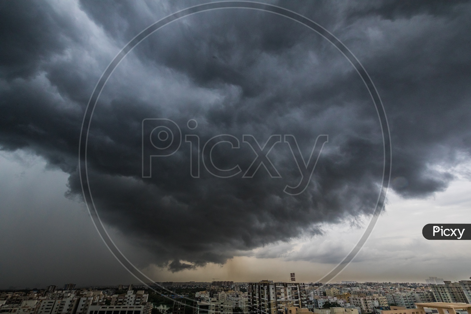 City Scape With High Rise Buildings On a Cloudy Day With Dark Black Clouds