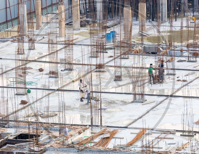 Aerial View Of Construction Workers on a Roof Top Of a Building