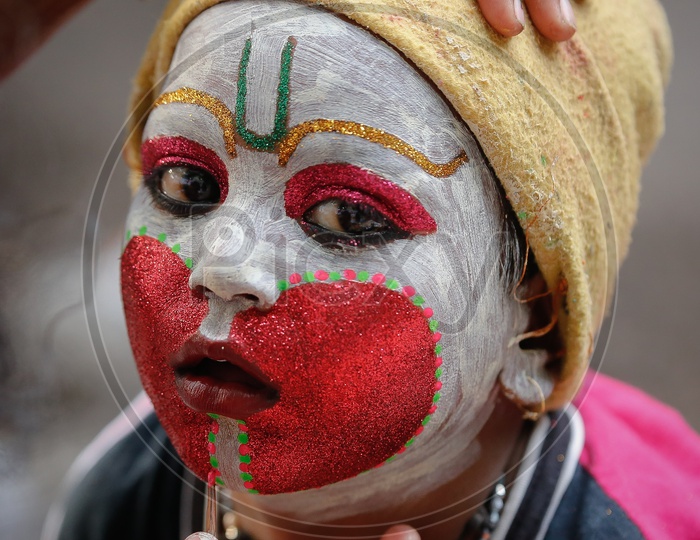 Makeup Artist Giving Final Touchings For a Boy As Hindu God Hanuman