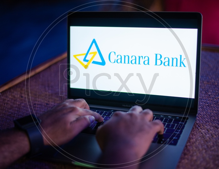 Indian Youth Accessing Online Banking Of  Canara  BANK  in Laptop