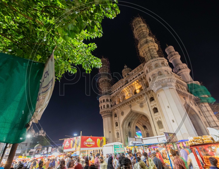 Crowd during the night in street bazaar with charminar in background