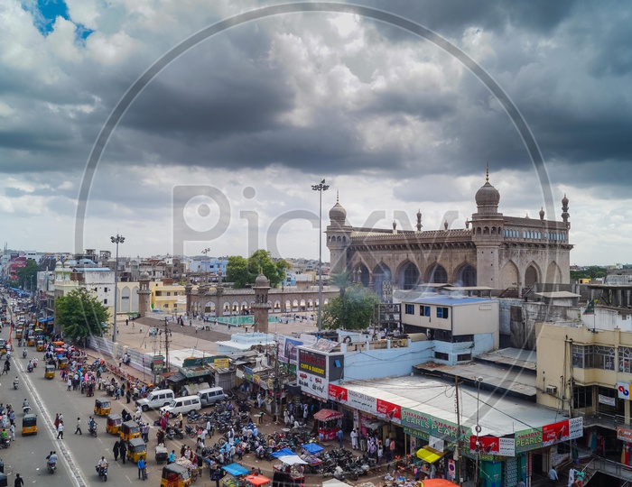 Street At Charminar With a View Of Mecca Masjidh And Dark Clouds In Sky