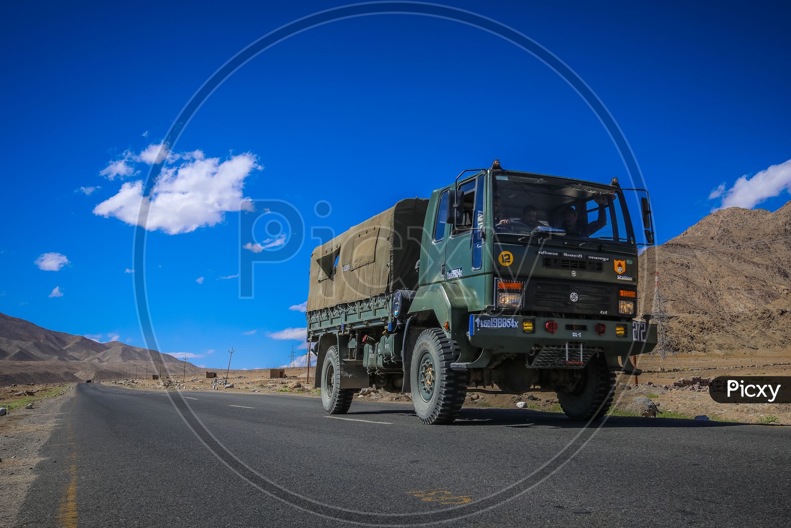 Military van of leh roads with mountains in the background