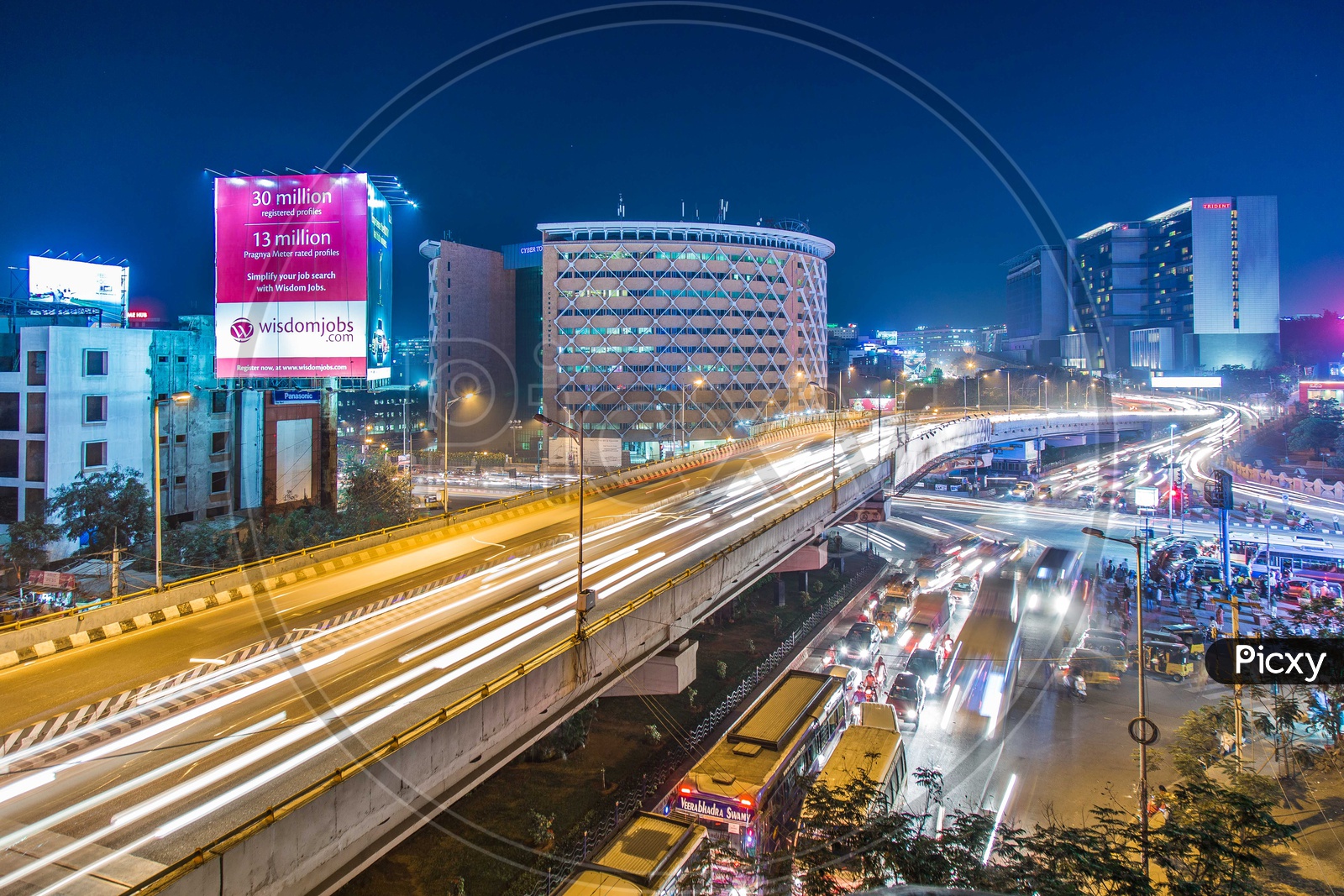 Long Exposure Shot Of Cyber Towers With Vehicles On Flyover
