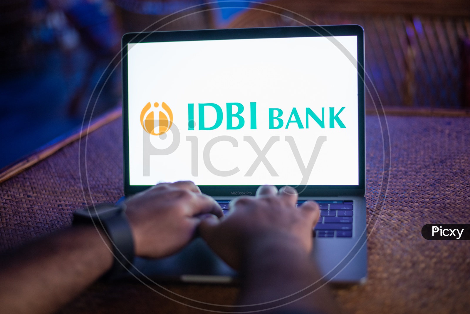 Indian Youth Accessing Online Banking Of IDBI  BANK  in Laptop