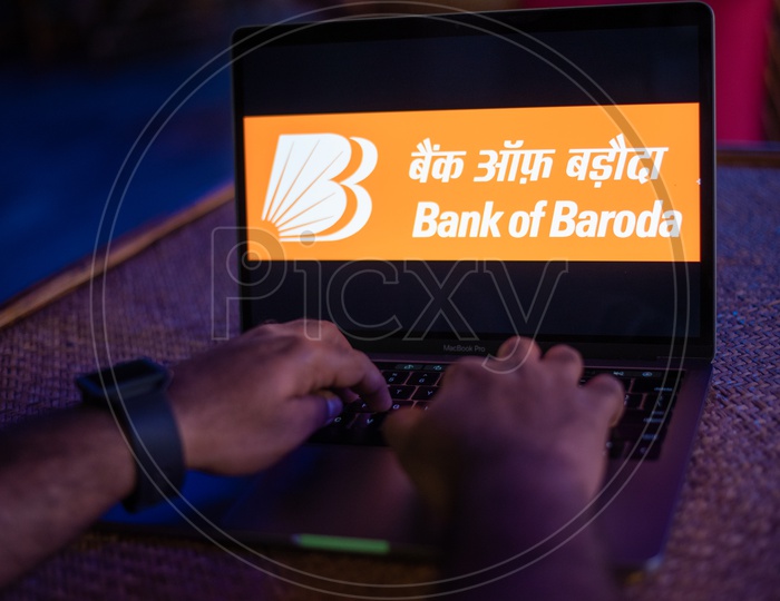 Indian Man Accessing Bank Of Baroda Online Portal in Laptop