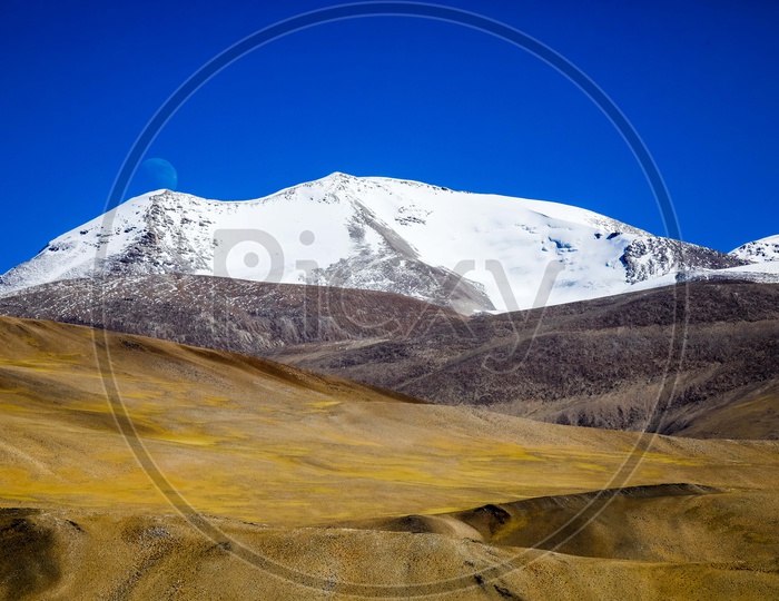 Landscape of the snow covered mountains with blue sky