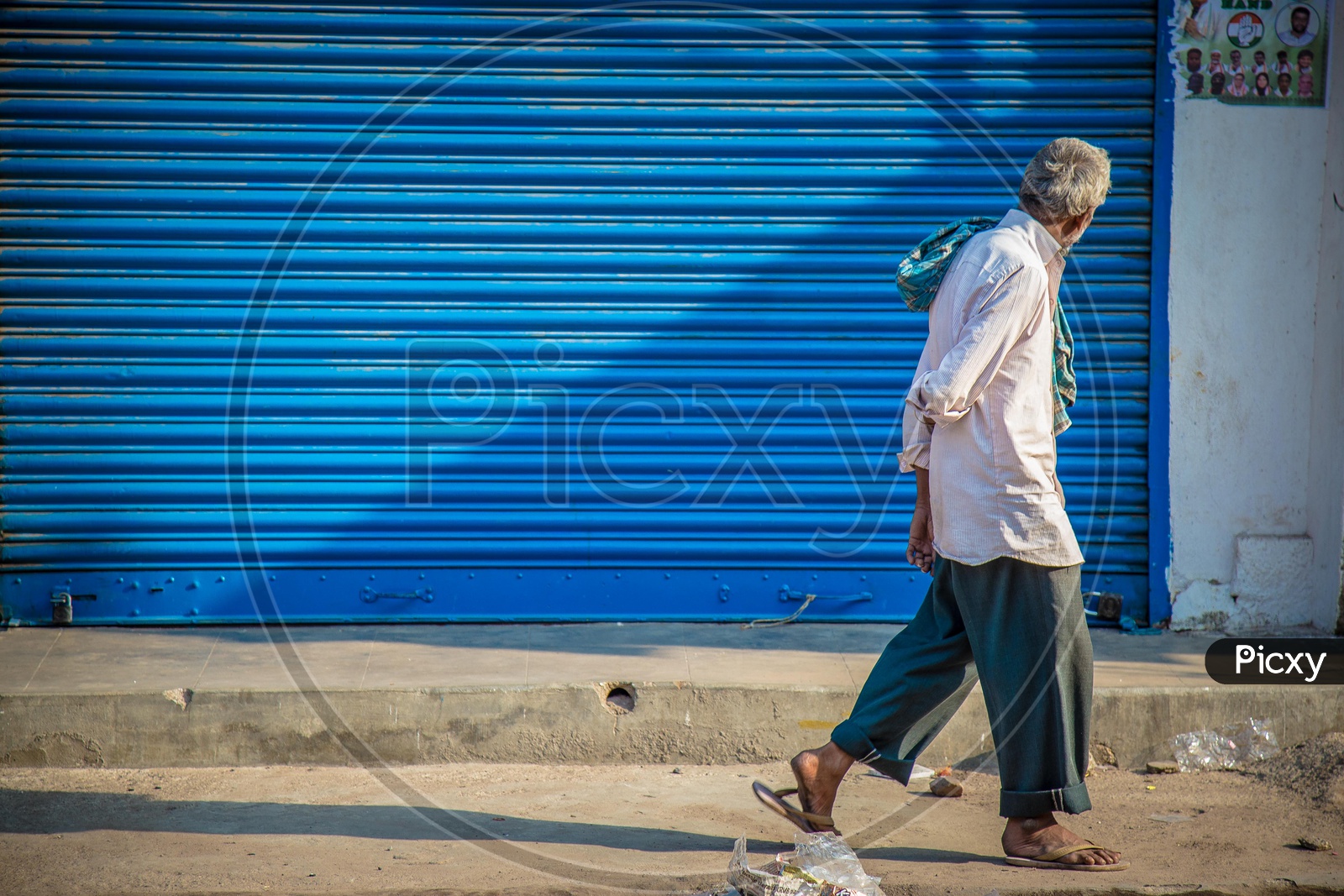 Old man walking by the street
