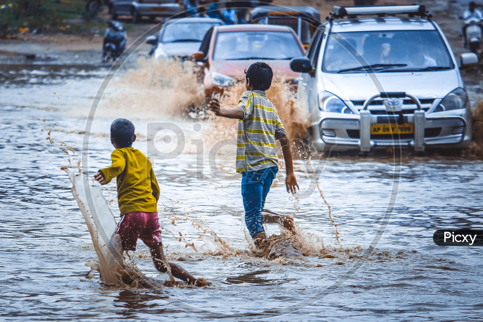 Children Crossing The Flooded Roads