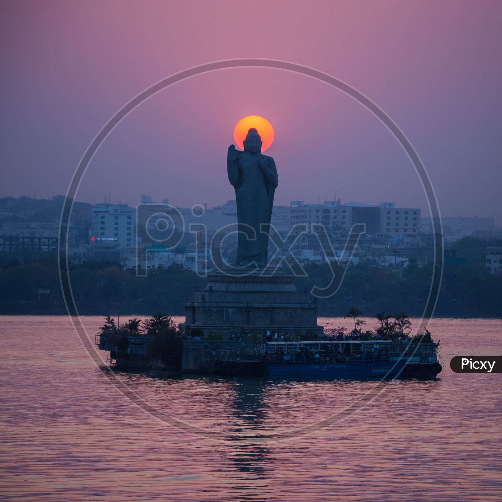 Buddha Statue in Hussain Sagar and Sunset in Background