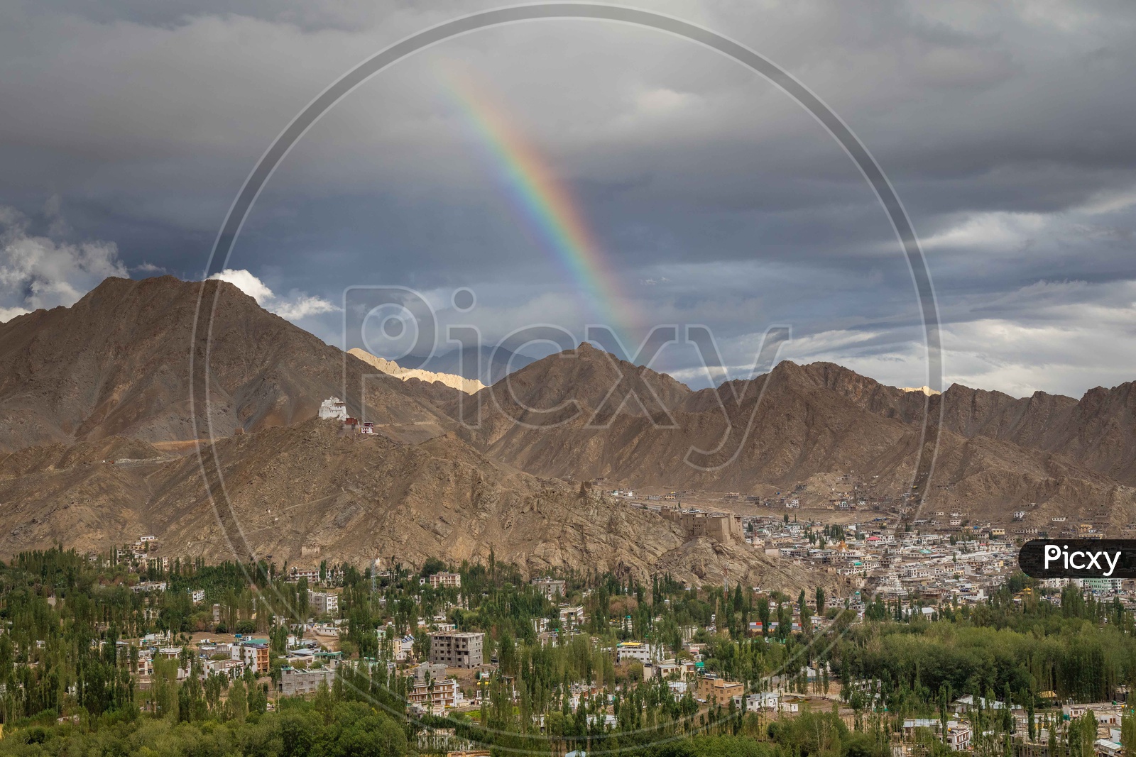 Beautiful mountains leh with Rainbow and leh village in the foreground