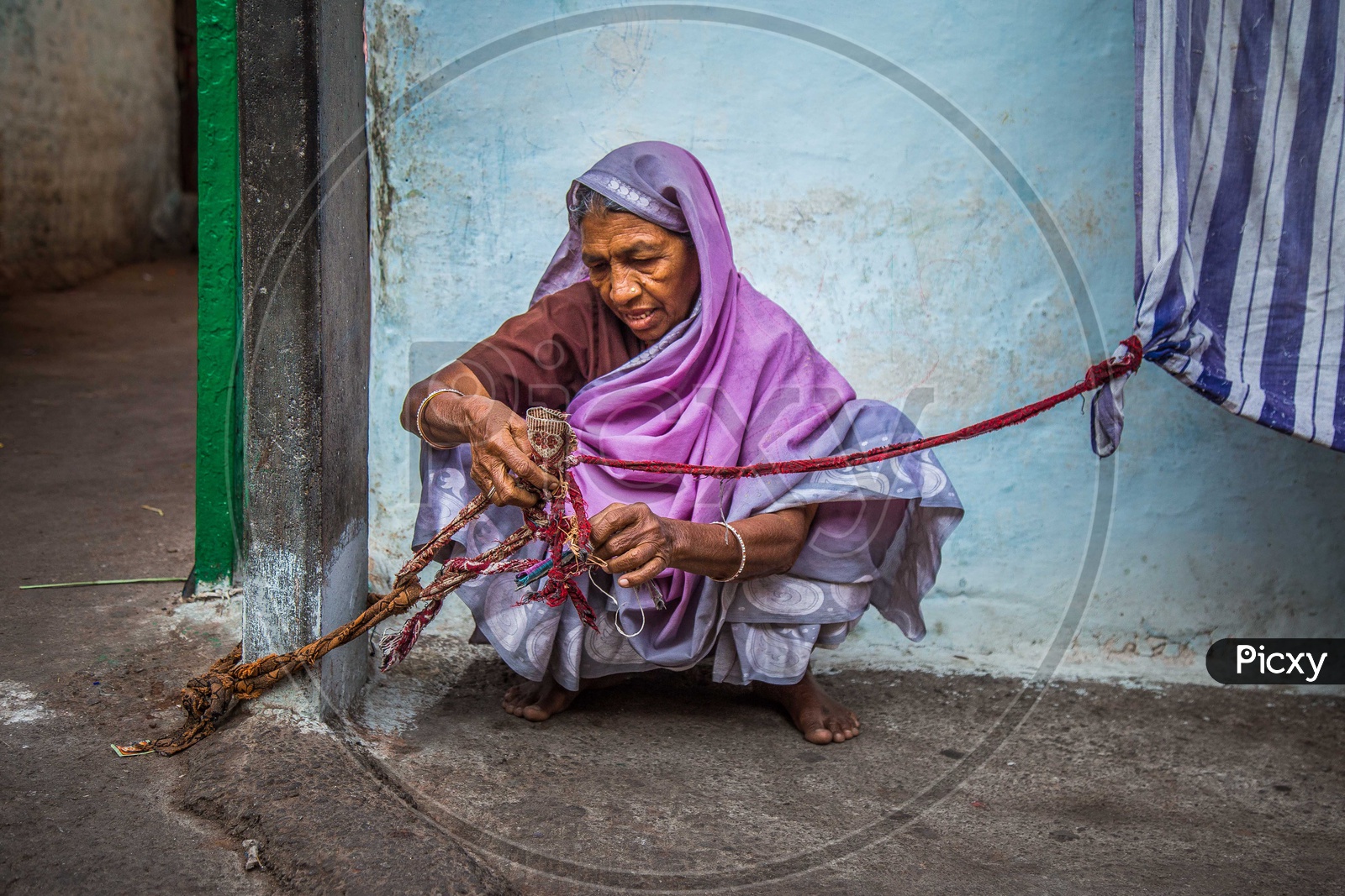 Portrait of an old woman holding the rope in a saree