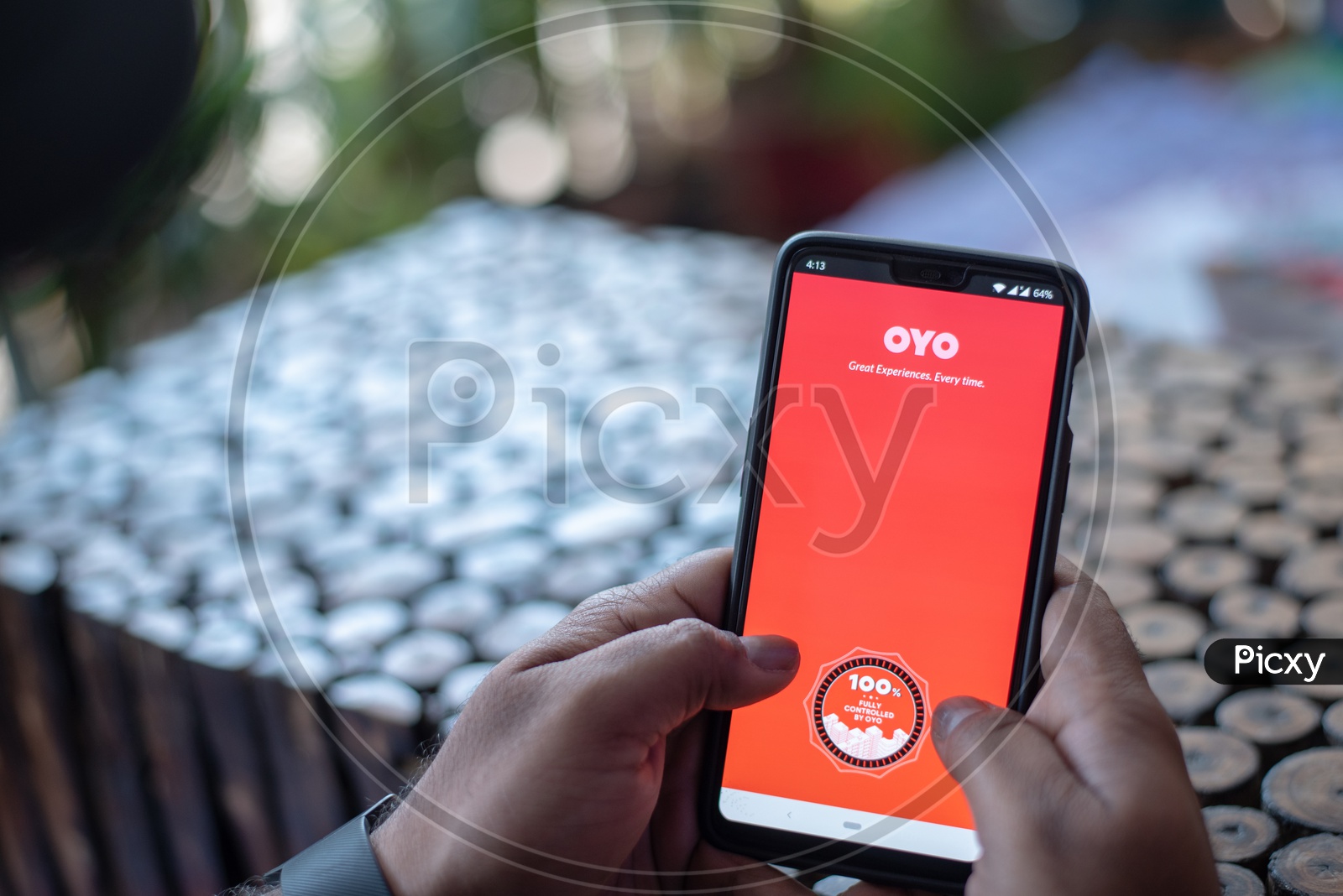 Indian Man Using OYO App in Smart Phone for Hotel Booking