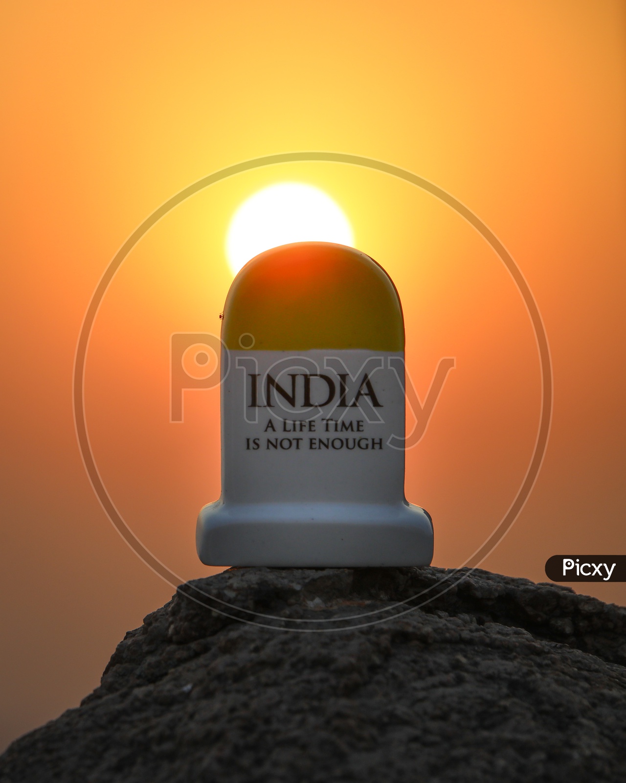 Miniature Mile Stone Of INDIA A Life Time Is Not Enough Tag Line  With a Sunset Background