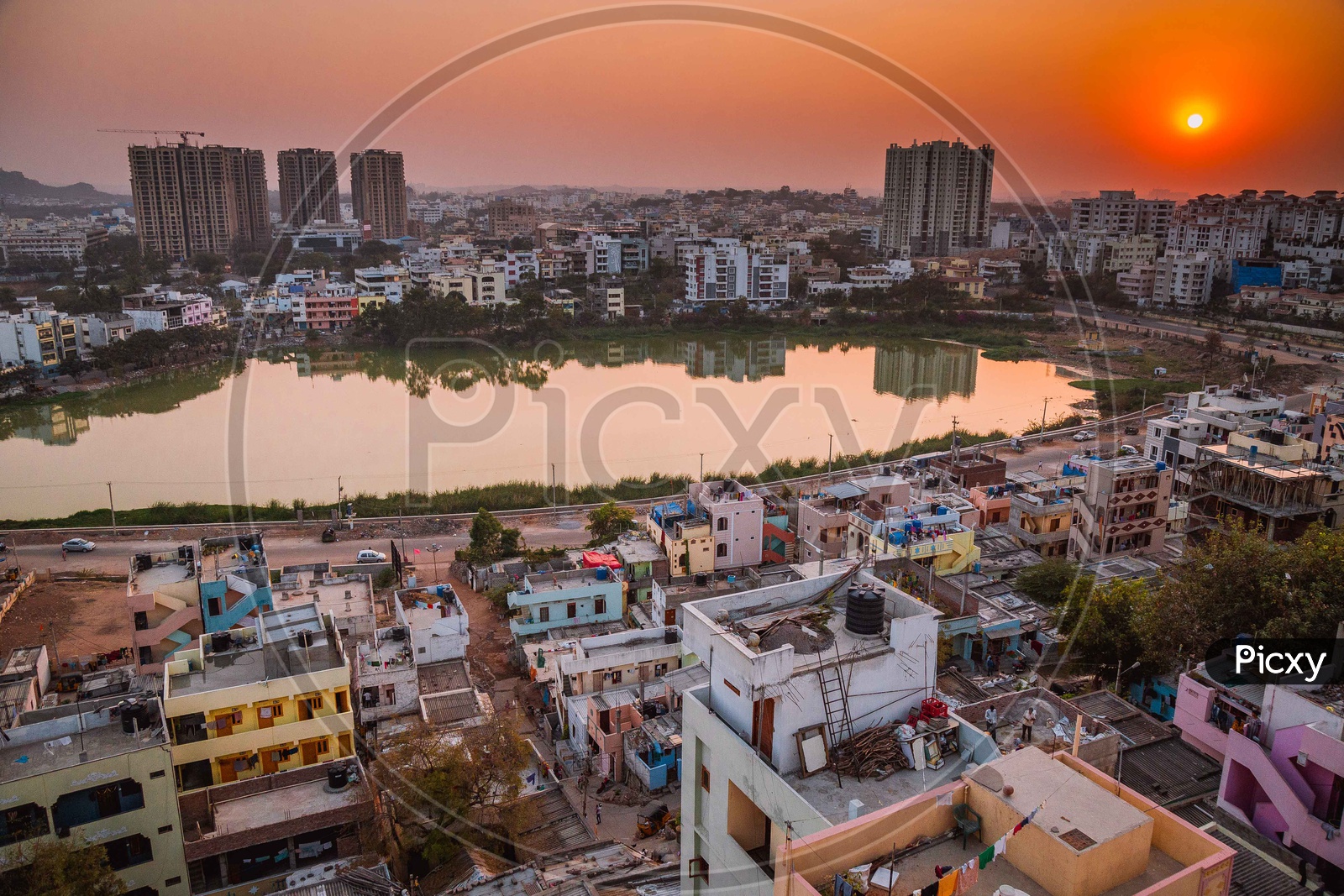 Sunset Over a City Scape View with Buildings and lake