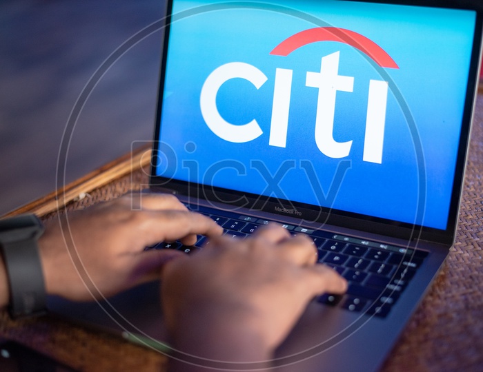 Indian Youth Accessing Online Banking Of Citi  BANK  in Laptop