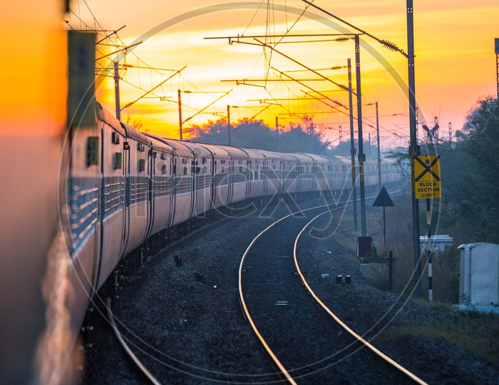 A View Of a Moving Train With Track And Electricity Poles