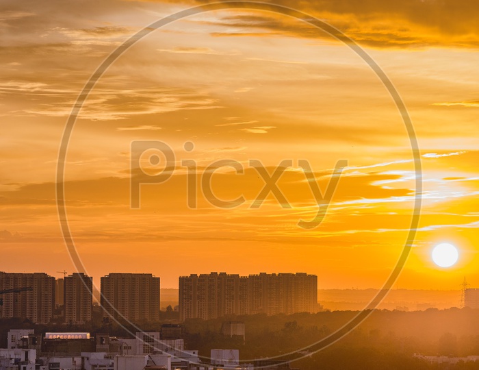 City Scape or landscape view from a hill top with a golden hour sunset background