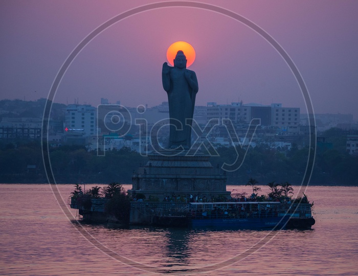 Buddha Statue in Hussain Sagar and Sunset in Background