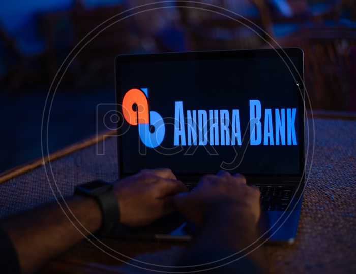 Indian Youth Accessing Online Banking Of Andhra  BANK  in Laptop