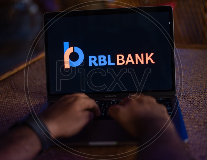 Indian Youth Accessing Online Banking Of RBL  BANK  in Laptop