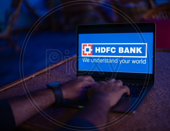 Indian Youth Accessing Online Banking Of  HDFC  BANK  in Laptop