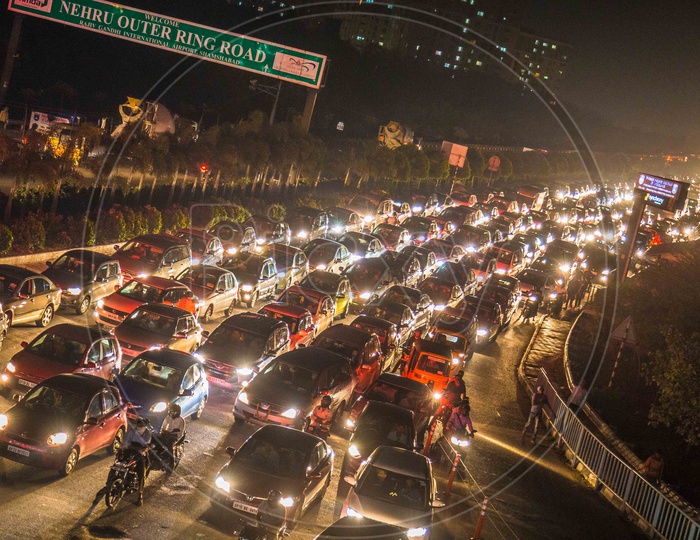 Vehicles struck in a heavy Traffic with their Headlights Glowing