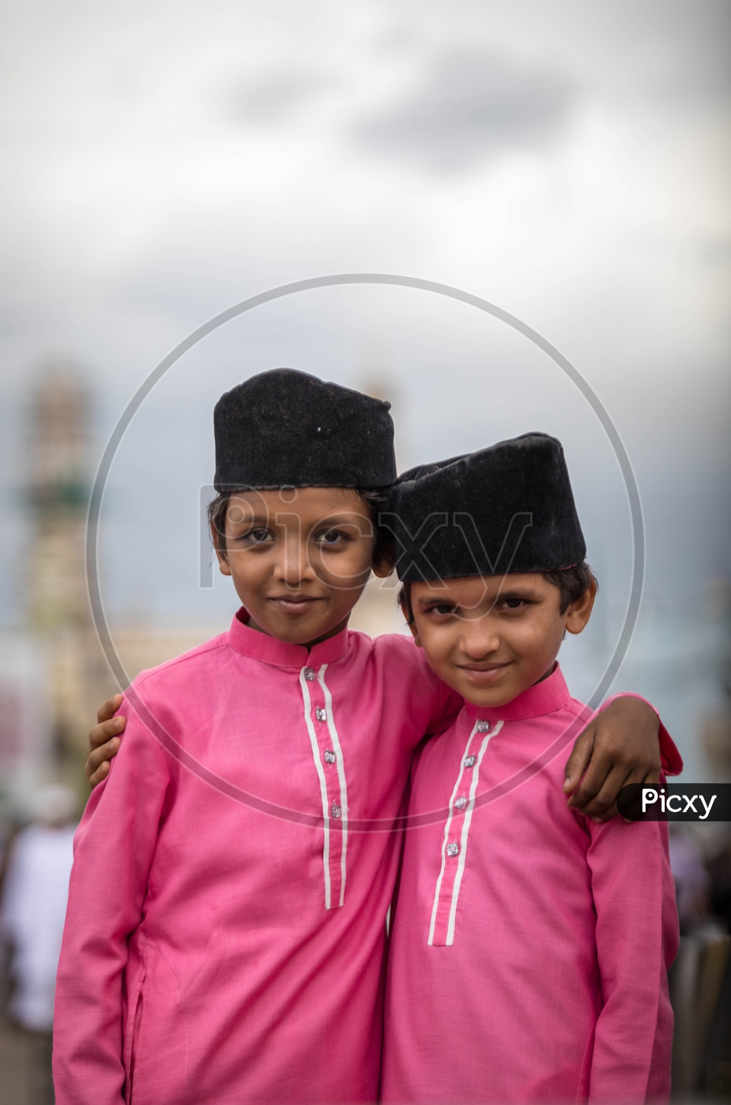 Portrait of two Muslim kids holding close each other. Ramadan Celebrations.