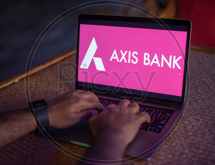 Indian Youth Accessing Online Banking Of  AXIS BANK  in Laptop