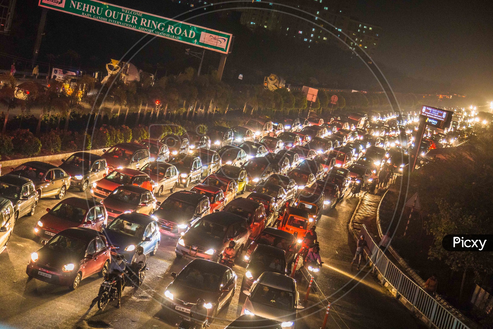 Vehicles struck in a heavy Traffic with their Headlights Glowing