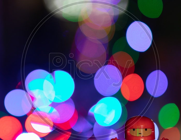 A Droid Bot Miniature Toy  With Led Bokeh Background
