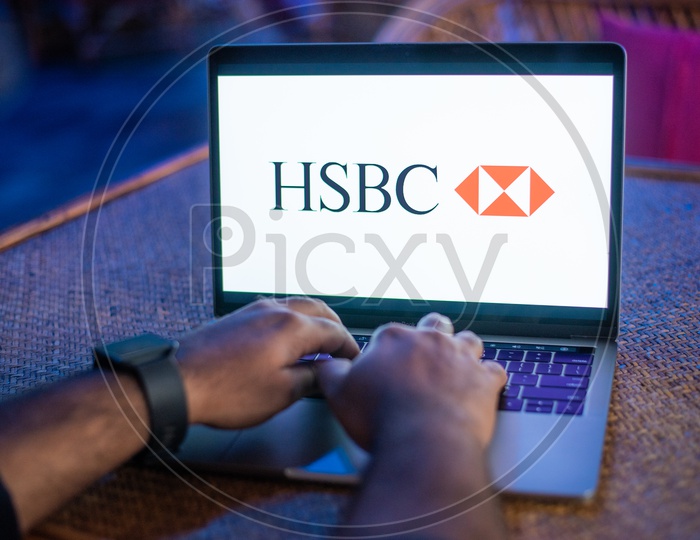 Indian Man Accessing HSBC Bank Online Portal In Laptop