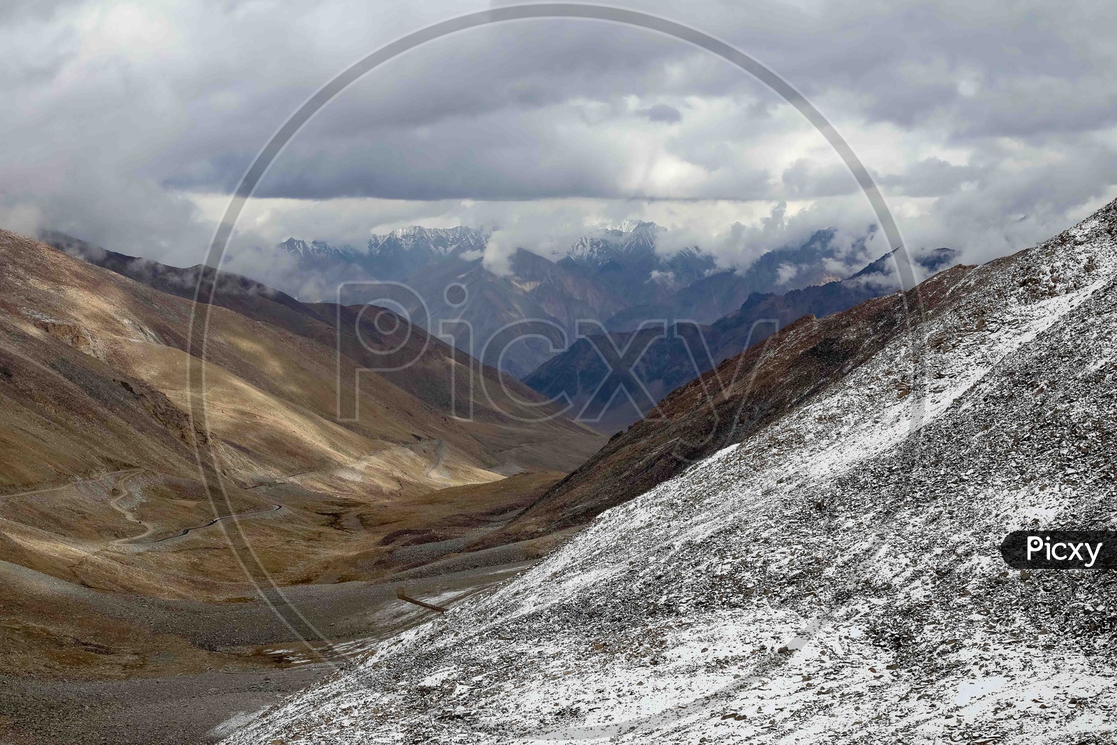 Landscape of cloudy snow capped mountains