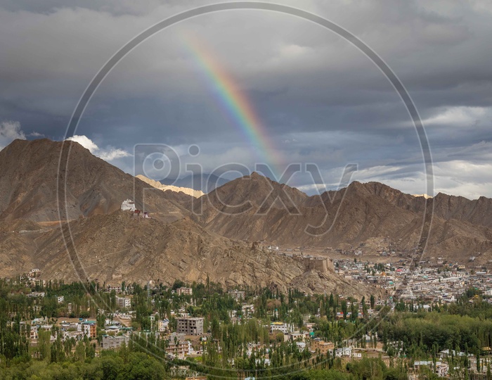Beautiful mountains leh with Rainbow and leh village in the foreground