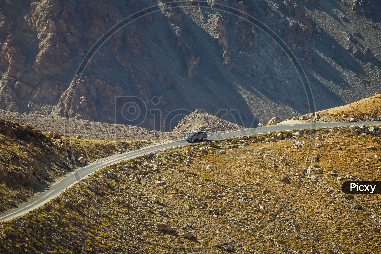 Moving car on the roadway amidst of hills