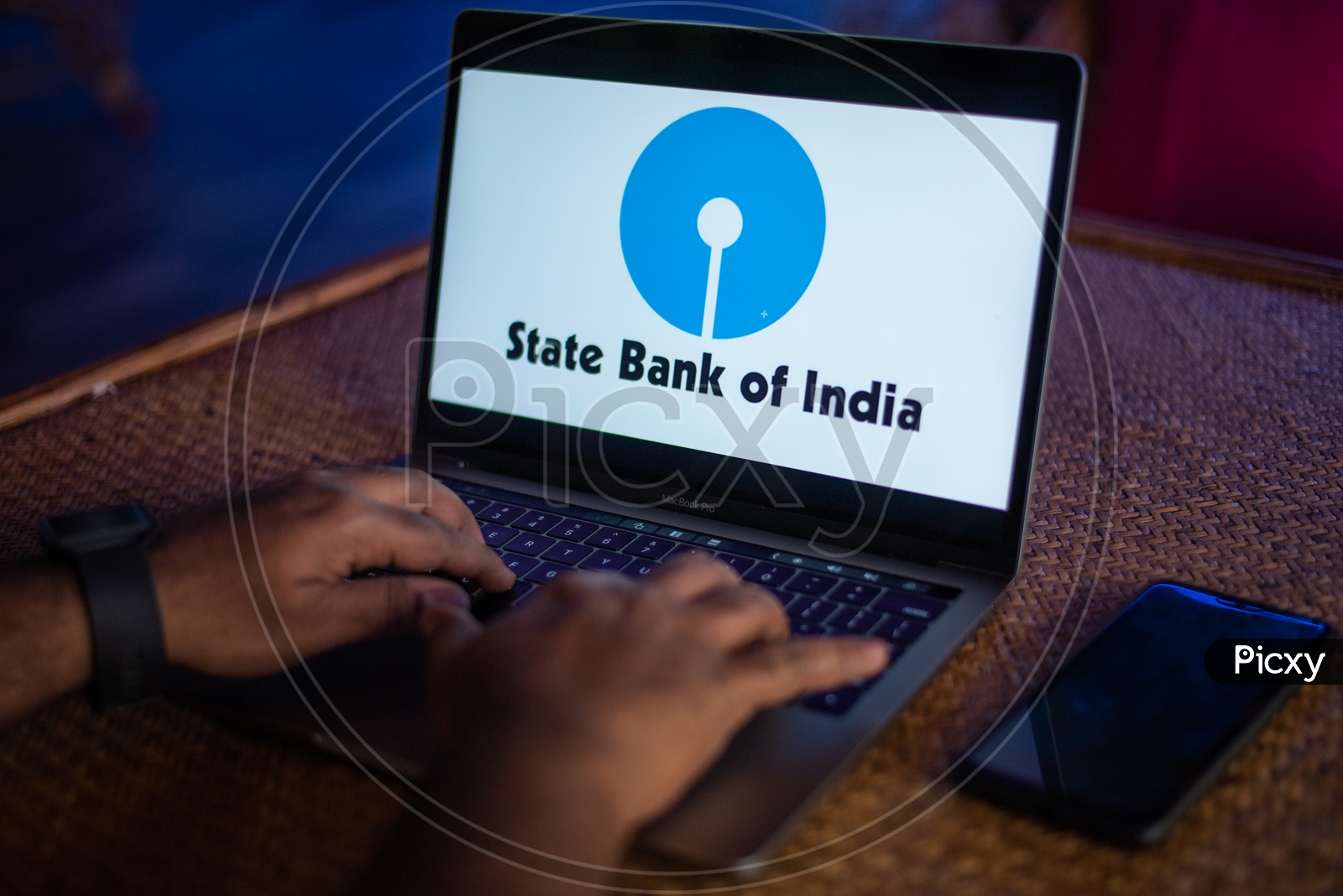 Indian Youth Accessing Online Banking Of State Bank Of India ( SBI ) in Laptop