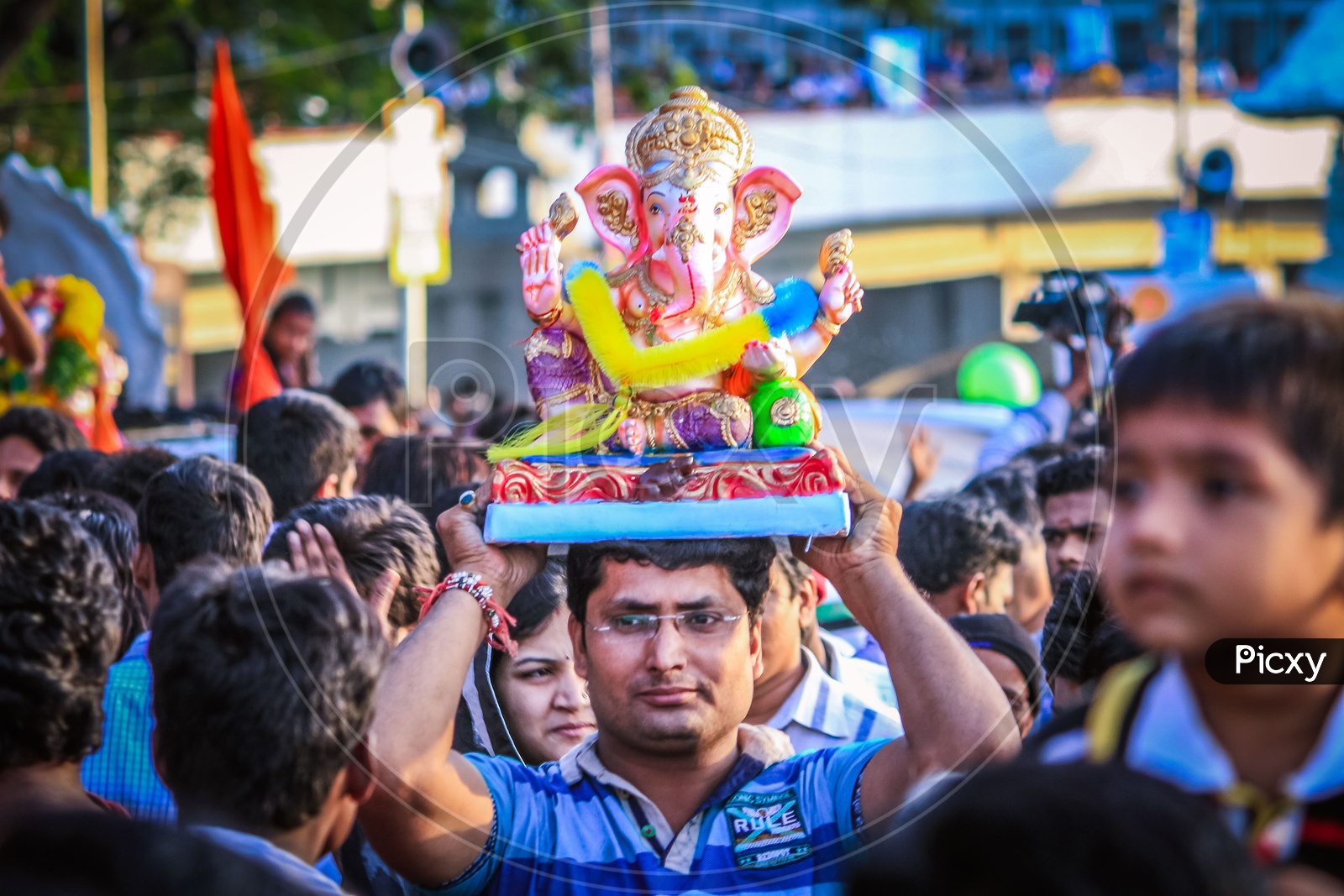 Man Carrying Lord Ganapathi or Ganesh Idol