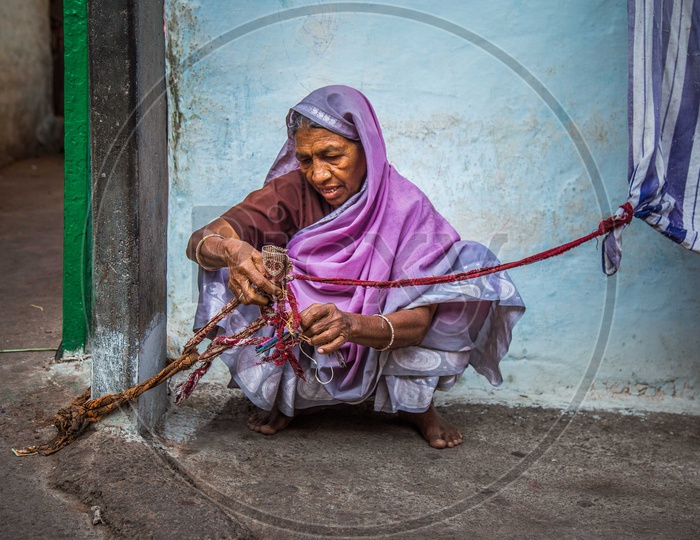 Portrait of an old woman holding the rope in a saree