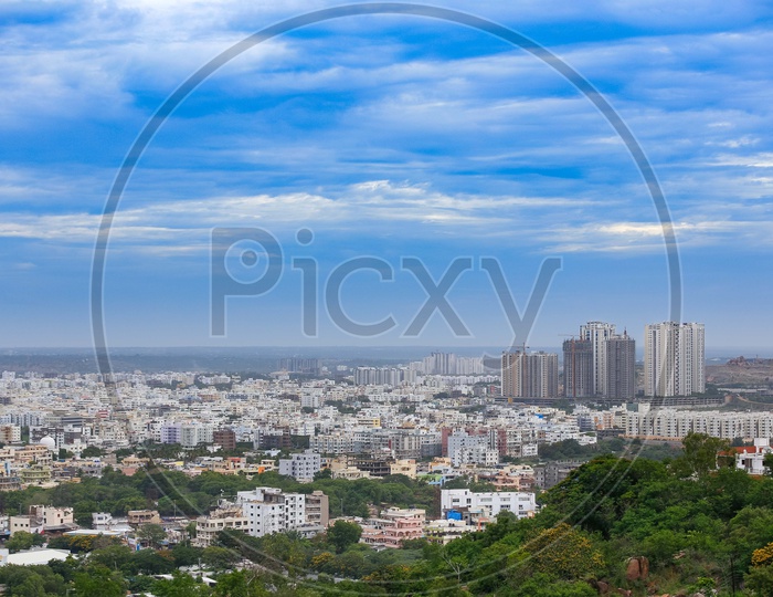 Hyderabad City Scape With High Rise Buildings And Apartments over  a Bluse Sky with Cotton Clouds
