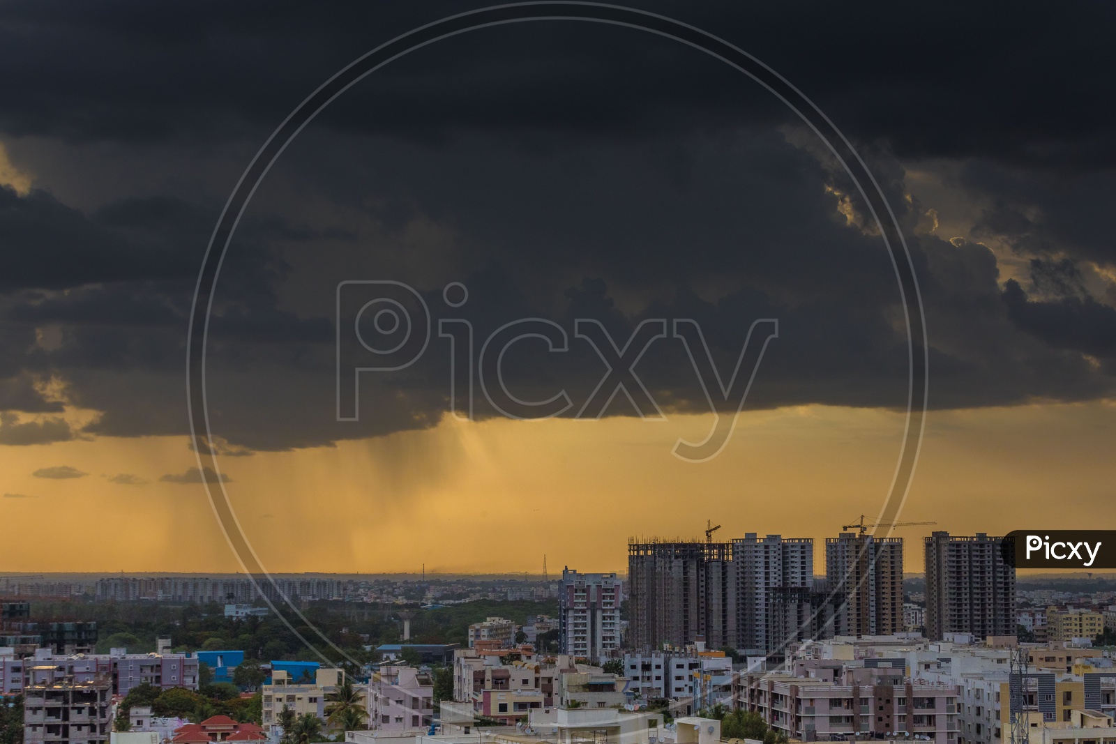 City Scape of Hyderabad With High Rise Buildings And Apartments On a Cloudy Day With Dark Clouds in background