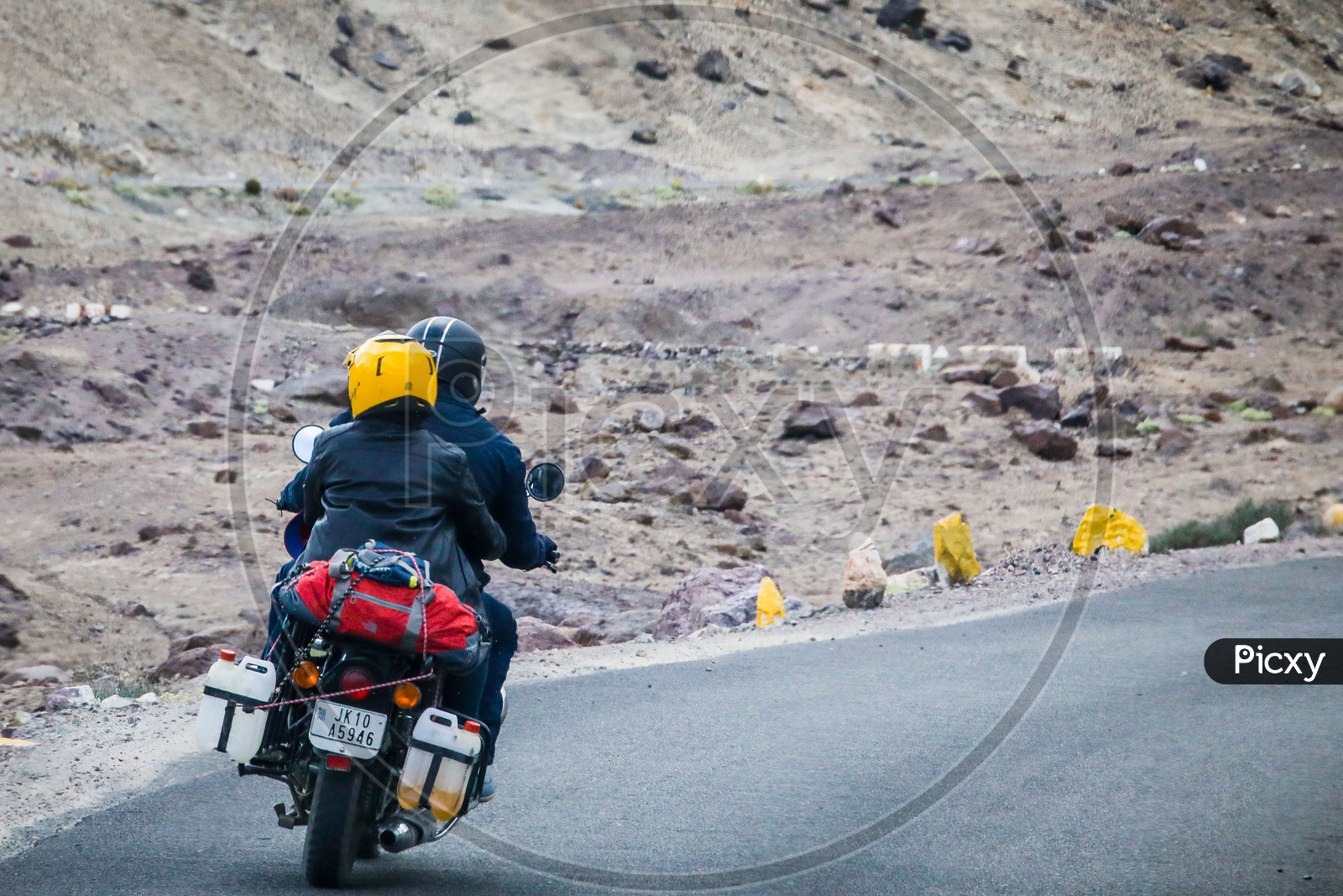 Riders on the motorcycle on the rural road through the mountains
