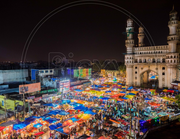 View of Crowd during the night in street bazaar with charminar in background