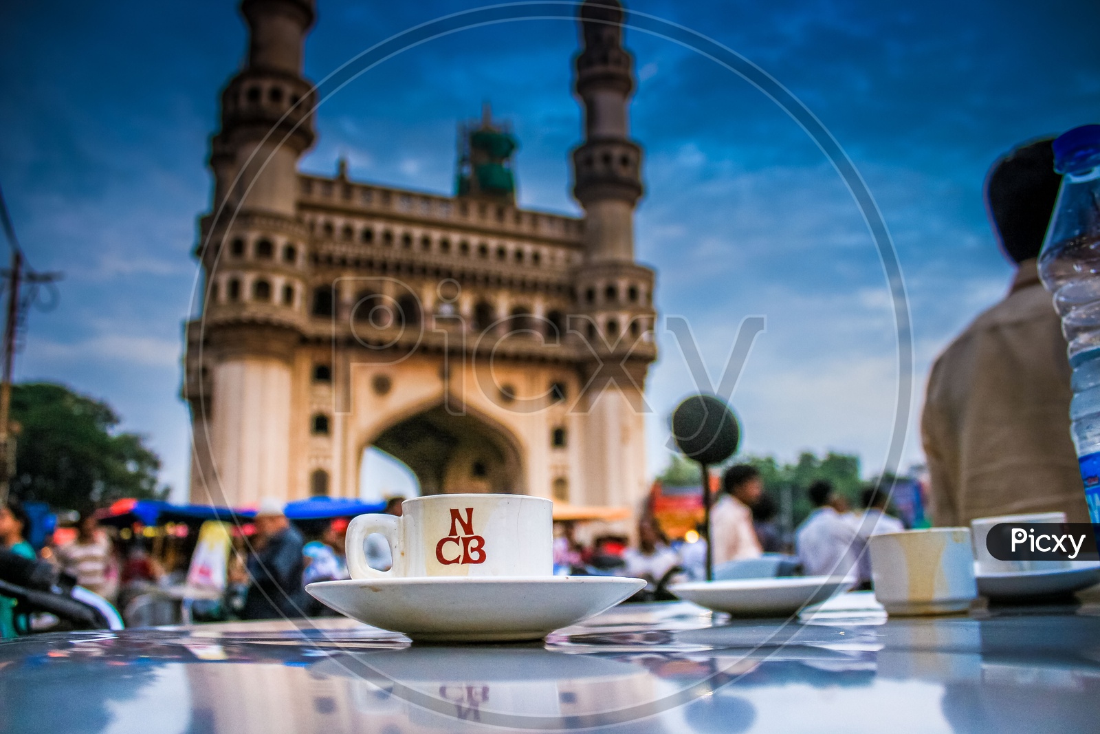 Tea cup in a saucer with Charminar in the background