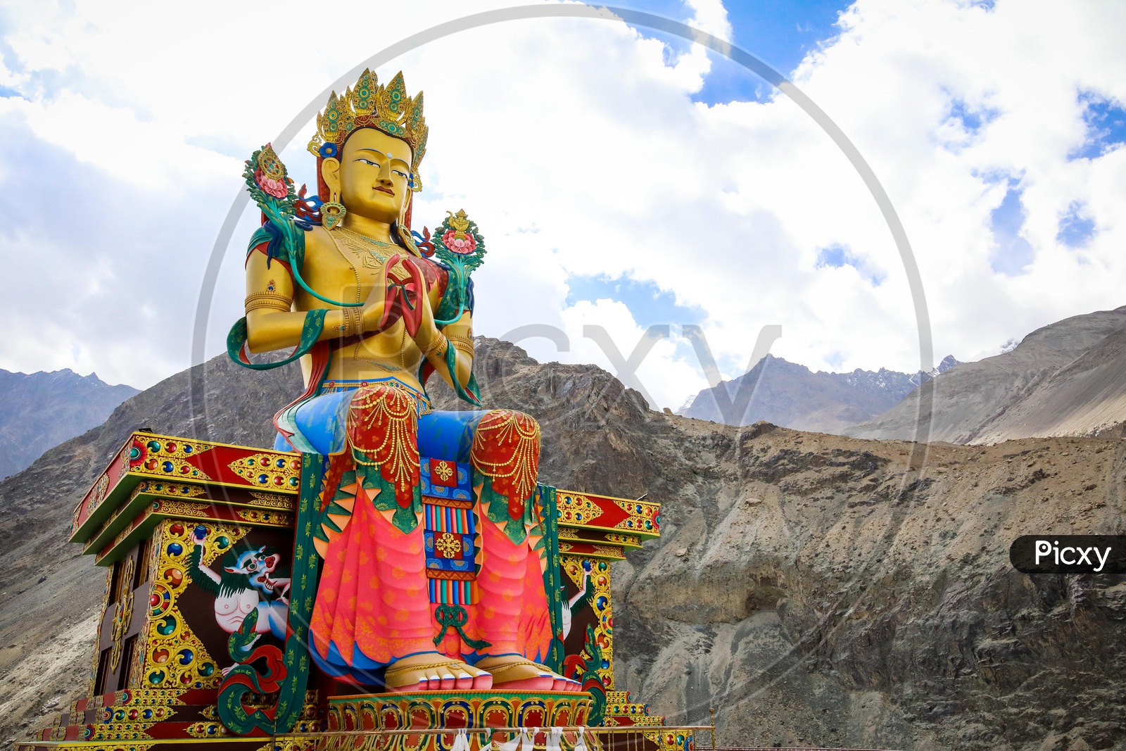 Giant Maitreya Statue alongside the mountains